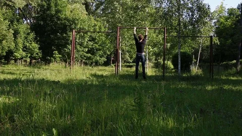 The man pulls himself up on the crossbar Stock Footage 76703817