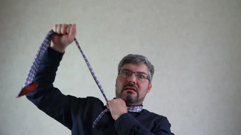 A man pulls himself by a tie 4K Stock-Footage 129529276