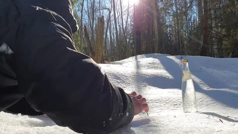 The man pulls his hand to a bottle of water. Stock Footage 105100531
