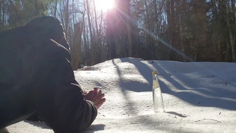 The man pulls his hand to a bottle of water. Stock Footage 105102286