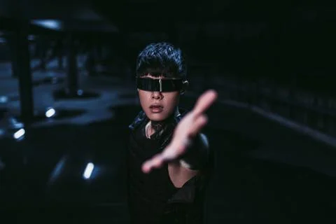 Man pulls his hand in the dark. The concept of the near future. Cyberpunk. Stock Photos
