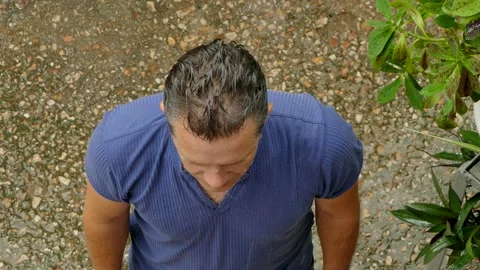 A man pulls his hands to heaven in the rain Stock Footage 86162984