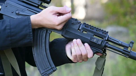 The man pulls a machine gun lock Stock Footage 60389254