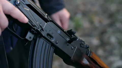 Man pulls the machine shutter Stock Footage 90393299