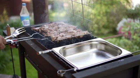 Man pulls meat grills, BBQ braizer Stock Footage 68712393