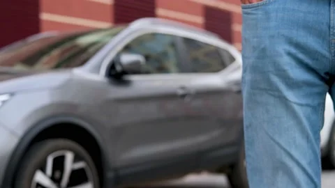 The man pulls out the car keys from his pocket. Stock Footage 153935592