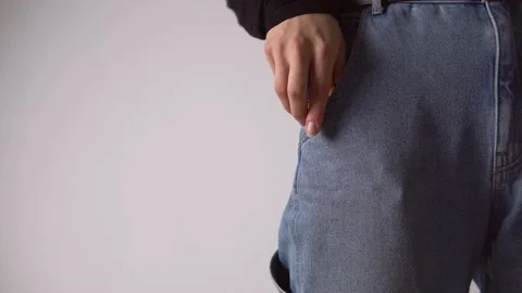 The man pulls out a clerical knife from his jeans pocket. Stock Footage 142778326
