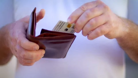 Man pulls out a document confirming Vaccination against Covid 19 from a purse. Stock Footage 153334722