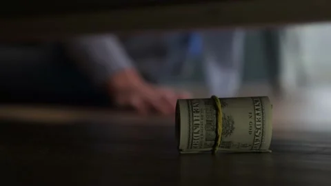 A man pulls out hidden dollars from under the bed, close-up Stock Footage 166802993
