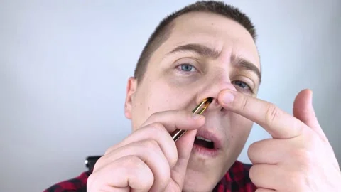 Man pulls out his nose hair with tweezers. Close-up of male hygiene products. Is Stock Footage 167255595