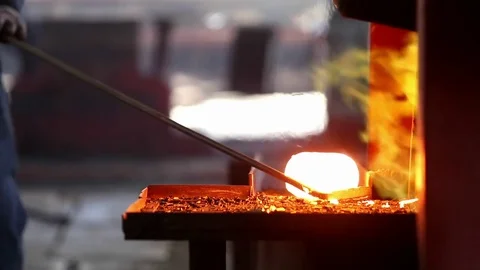 Man pulls out industrial smelting furnace hot metal and drags to the press Stock-Footage 76856904