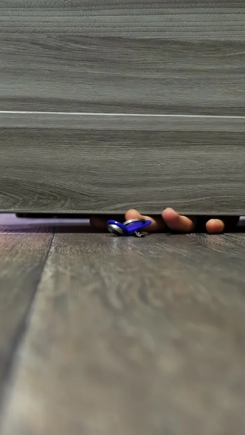 Man pulls out keys through the crack under the door.  Stock Footage 324791372