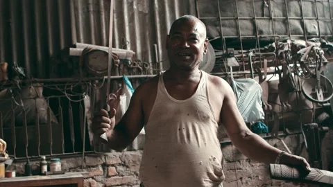 Man pulls out large knife from a knife sheath in workshop Stock Footage 166846171