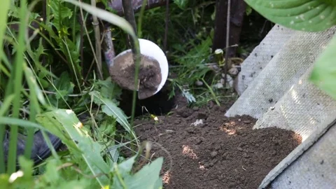 Man pulls out of the pit land with the help of special devices. Tool for setting Stock Footage 82999956