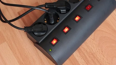 Man pulls out the plug from the surge protector. Stock Footage 70558261