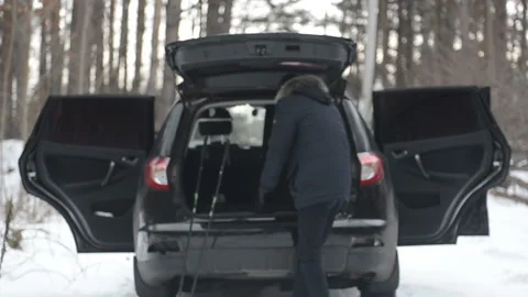 A man pulls out ski from the car trunk 動画素材 101601410