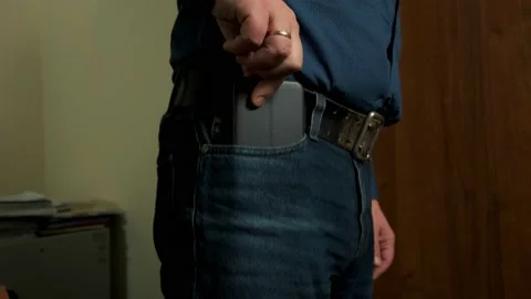 The man pulls out a smartphone from his jeans pocket Stock Footage 150695024