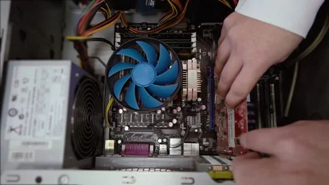 A man pulls out a video card from a computer system unit Stock Footage 151601675
