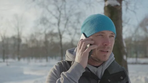 A man pulls a phone out of his pocket and talks Stock Footage 102281264