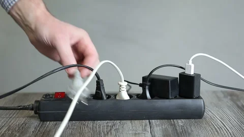 Man pulls plug from extension cord.Disconnecting electrical appliances Stock Footage 243104896