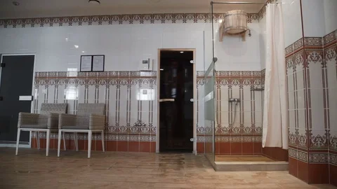 The man pulls the rope and pours the water out of the bucket. Cold shower in Stock Footage 75493862