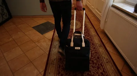 The man pulls a suitcase in hotel Stock Footage 60702566