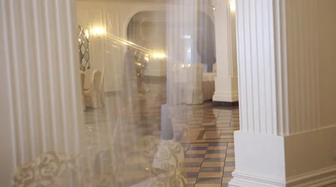 The man pulls a suitcase in hotel. It passes through the wall of mirrors. Stock Footage 60702890