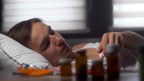 A man pulls a thermometer and checks the temperature. Illness, viral disease Stock Footage 125809833