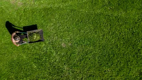 Man pulls a wheelbarrow with garbage top view Stock Photos