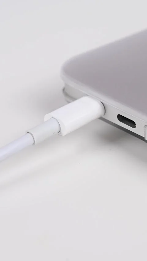 The man pulls the wires into the laptop. Vertical video. Stock Footage 274301306