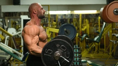 Man pumping up biceps muscles workout fitness and bodybuilding Video stock 119076811