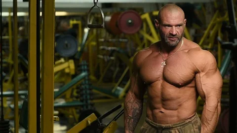 Man pumping up biceps muscles workout fitness and bodybuilding Stock Footage 119076845