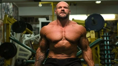 Man pumping up biceps muscles workout fitness and bodybuilding Video stock 119076914