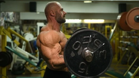 Man pumping up biceps muscles workout fitness and bodybuilding Video stock 119077033