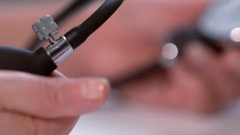 Man pumping the bulb of a sphygmomanometer Stock Footage 125895807