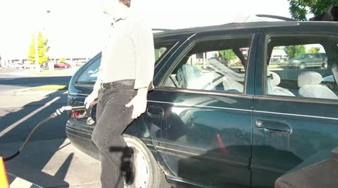 Man Pumping Gas in Sun Video stock 12598108