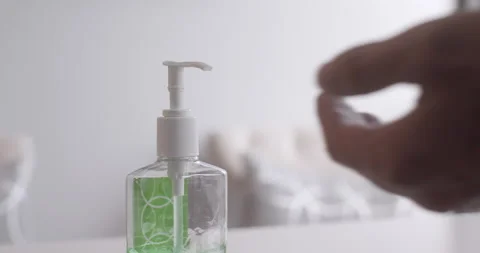 Man pumping hand sanitizer into left hand 動画素材 130665431