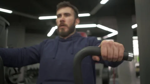 The man pumping his arm muscles in the gym with a trainer with weights. Stock Footage 129572353