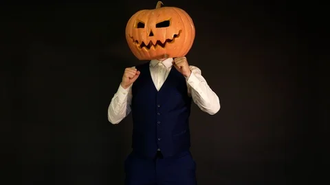 A man with a pumpkin head dancing.carved pumpkin Halloween concept Stock Footage 116226699