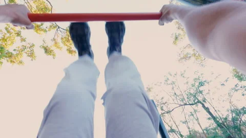 A man pumps his abs on a horizontal bar. From the first person. Video stock 316845475