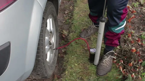 Man pumps the wheel Stock Footage 56140725