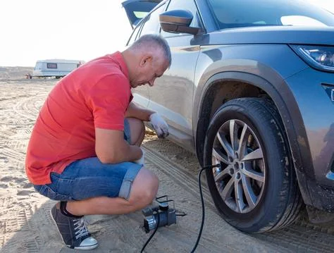 The man pumps up the wheel. Stock Photos
