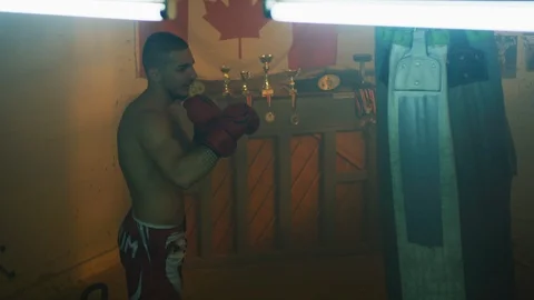 Man punching the boxing bag Stock Footage 100035086