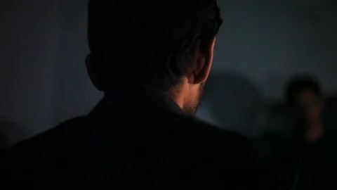 Man punching the other one which is tied and had a black colored bag at his face Stock Footage 106700573