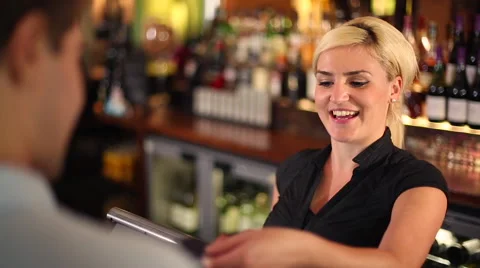 Man Purchasing Items From an Employee at a Bar Stock Footage 44086311