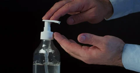 Man push dispenser and liquid soap squeezed out to hand, black background. Stock Footage 142236465