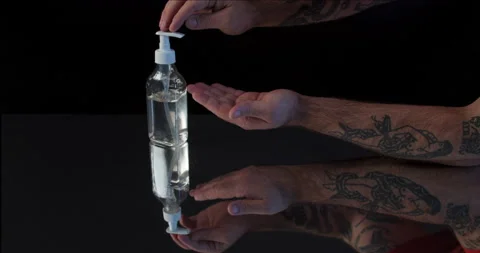 Man push dispenser and liquid soap squeezed out to hand, closeup shot against Stock Footage 142236540