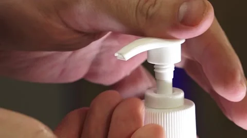 Man push dispenser and liquid soap squeezed out to hand Stock Footage 149916364