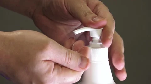 Man push dispenser and liquid soap squeezed out to hand Stock Footage 149916370