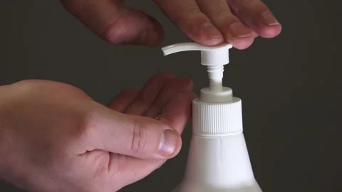 Man push dispenser and liquid soap squeezed out to hand Stock Footage 149916435